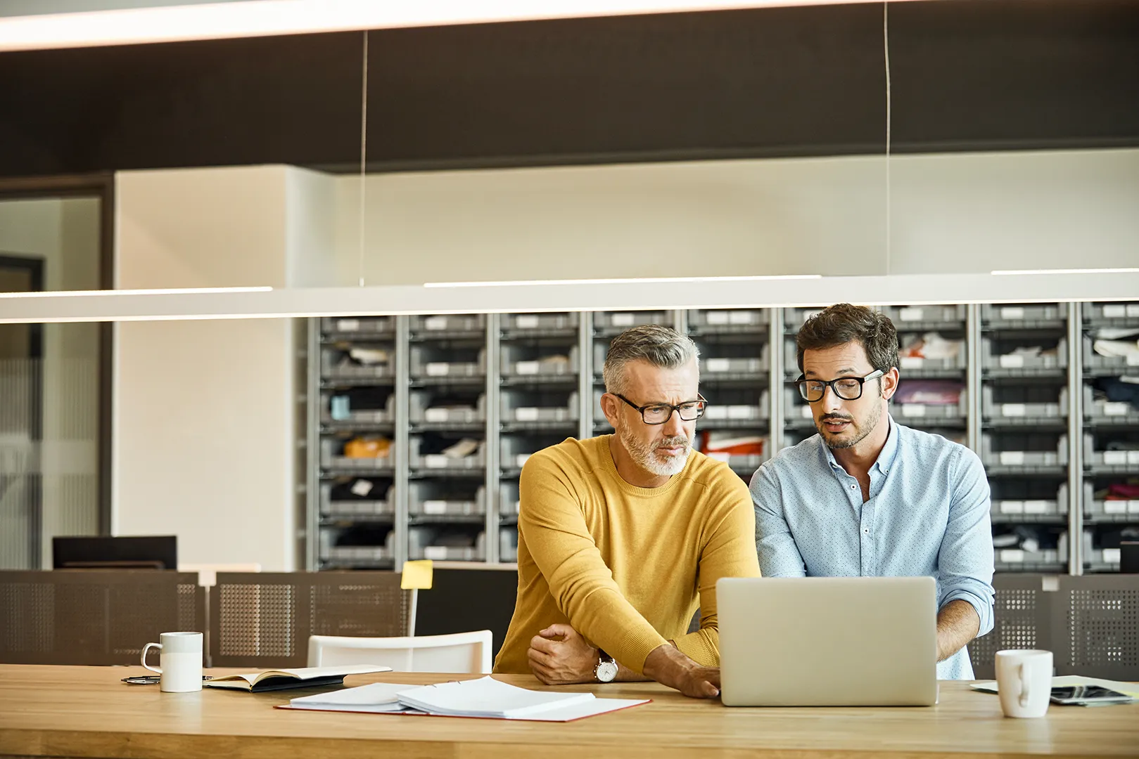 businessmen working together on a laptop in an office