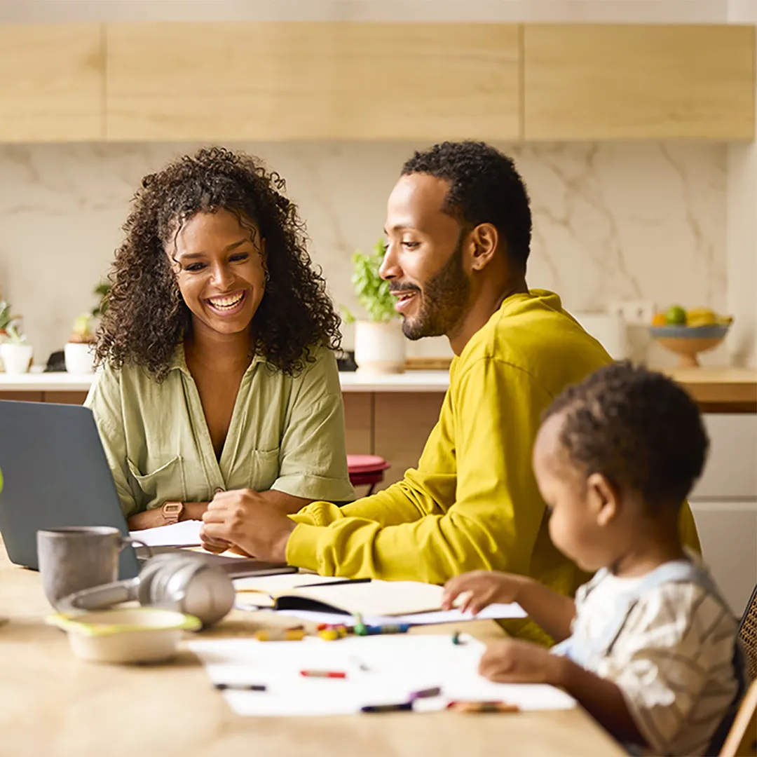 family at home looking at a laptop