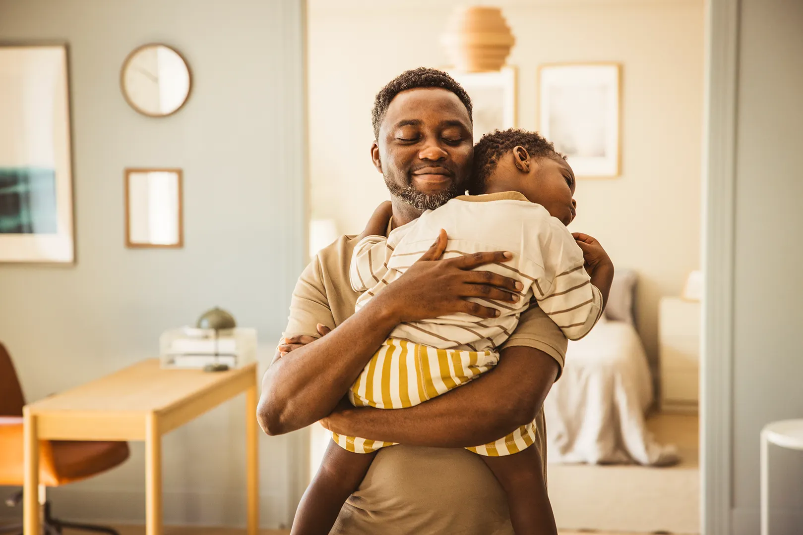 man holding sleeping son