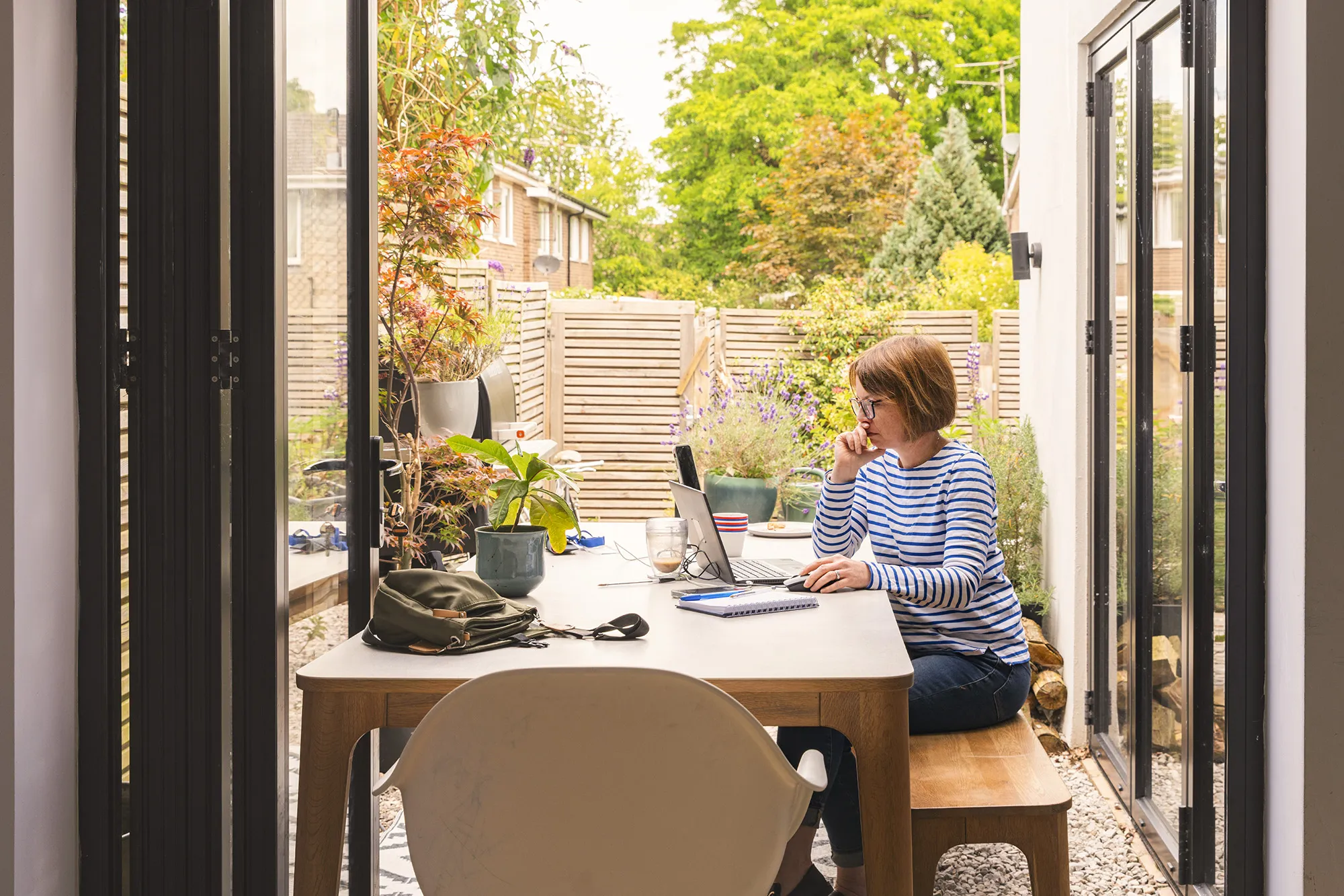 older woman working in her backyard