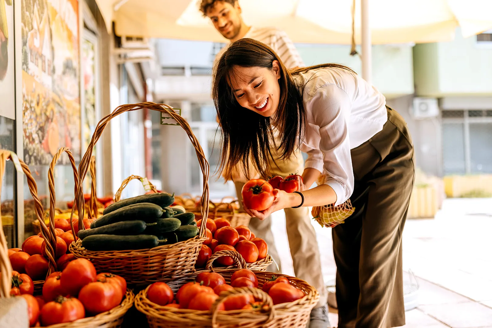 woman picking apples at market