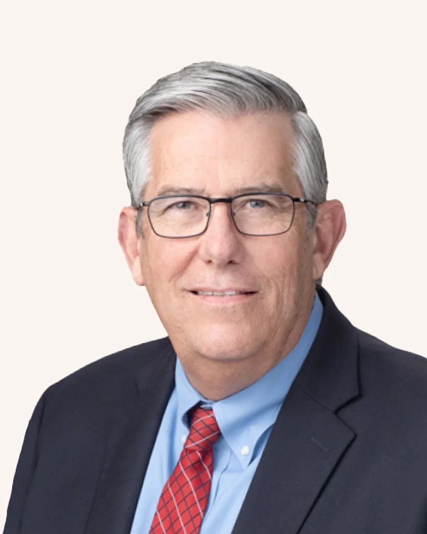 Headshot of a man smiling in a suit