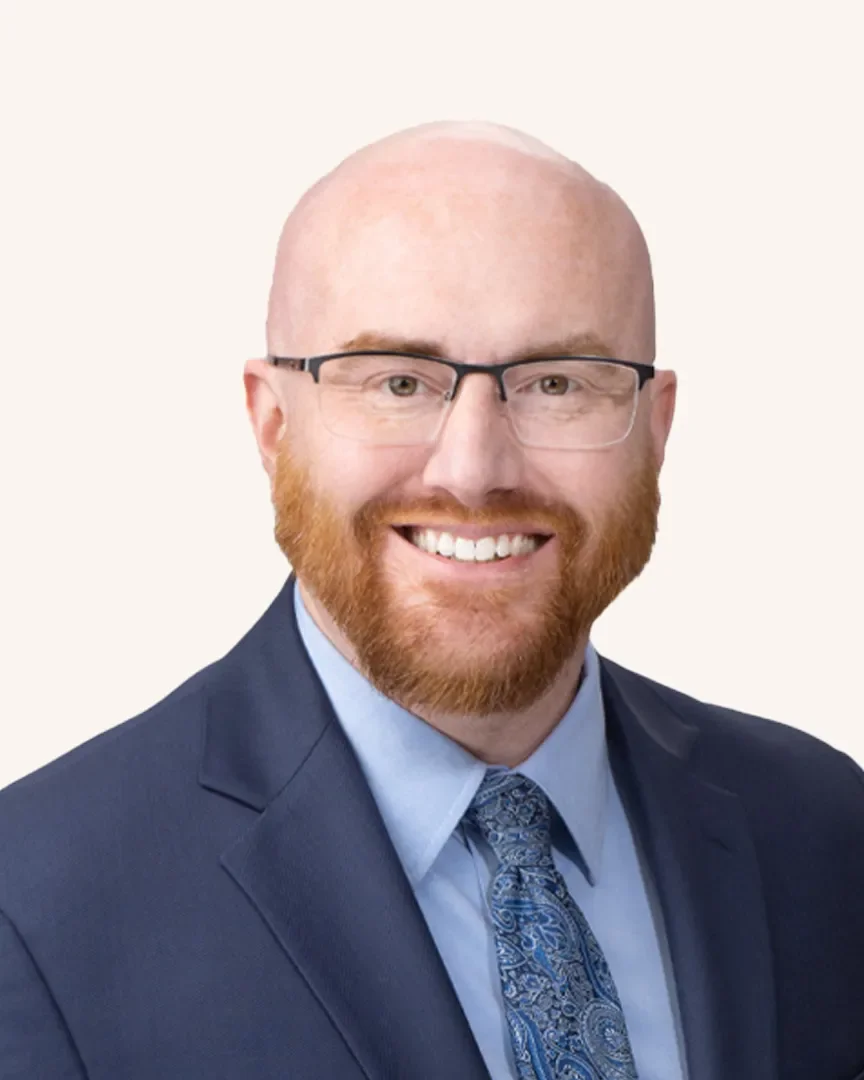 Headshot of a man smiling in a suit