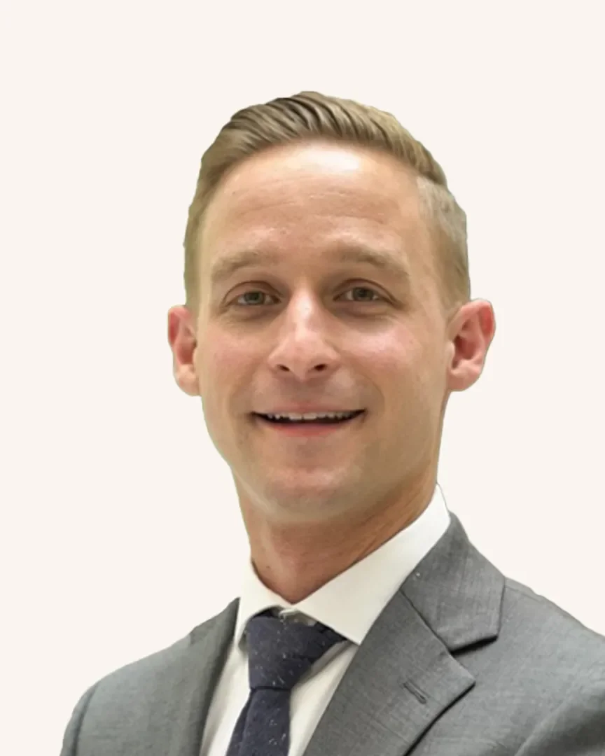 Headshot of a man smiling in a suit